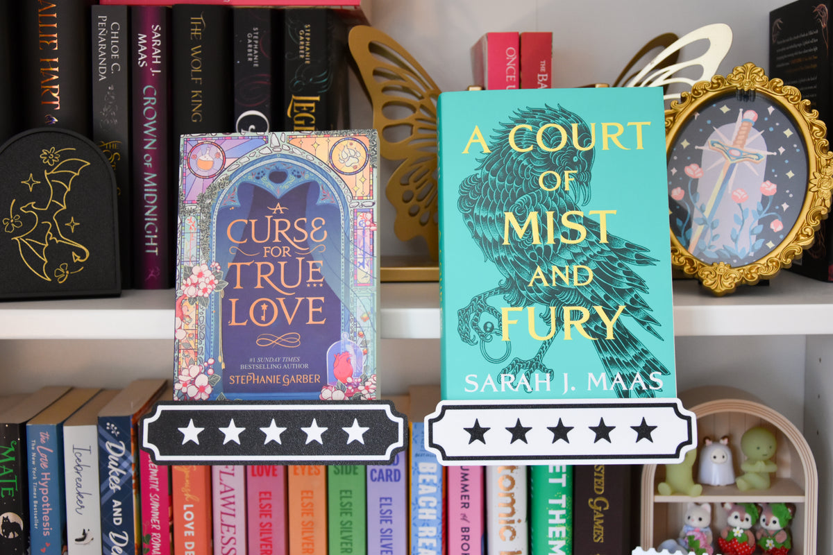 Two book covers displayed on a bookshelf: 'A Curse of True Love' by Stephanie Garber and 'A Court of Mist and Fury' by Sarah J. Maas, with star rating overlays at the bottom.